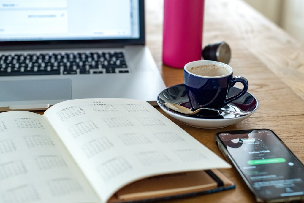 Example of a personal productivity system that involves a laptop, calendar and a coffee mug